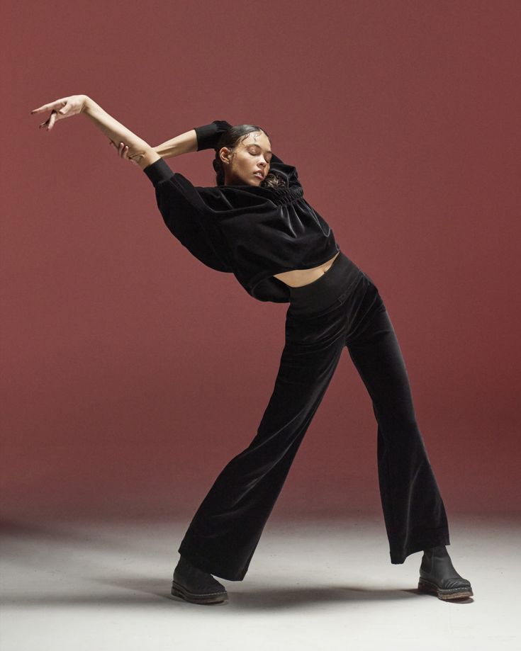 Dancer in black velvet on a terracotta studio set