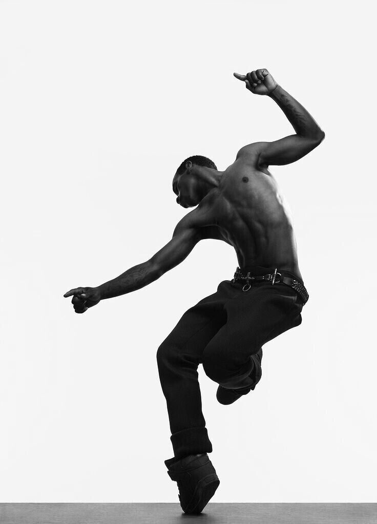 Dancer in a dynamic pose against a white studio background